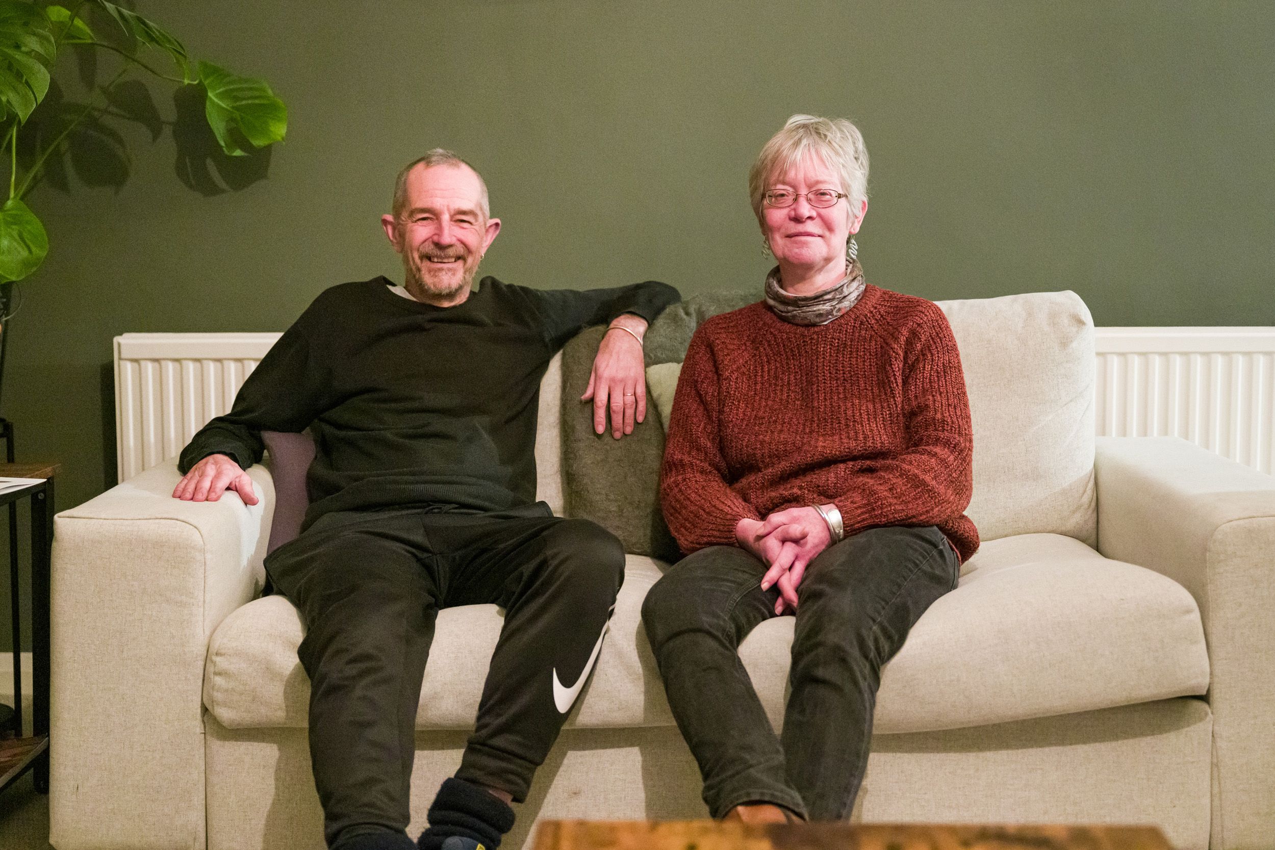Compassionate Open Homes Nottingham volunteer hosts seated together, ready to provide a safe and welcoming space for young people facing homelessness.