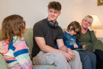 A heartwarming scene of a diverse Open Homes Nottingham family together, depicting the inclusive support network for young individuals in need.