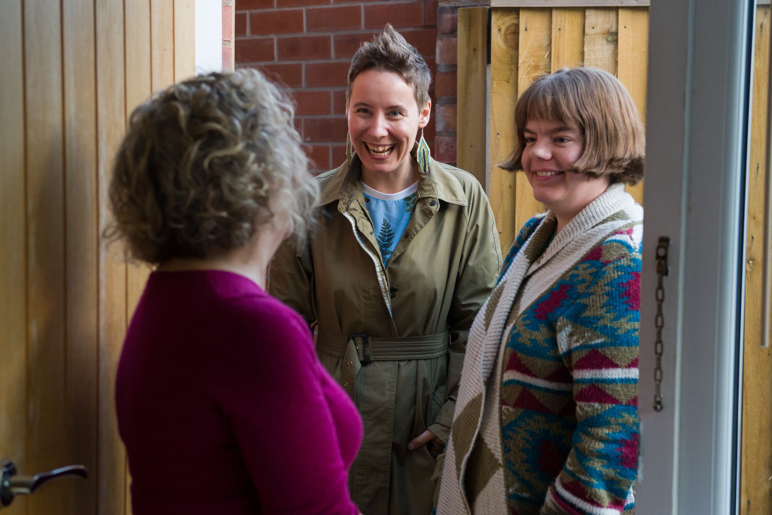 Open Homes Nottingham volunteers welcoming a young woman at the doorstep, providing support for homeless youth