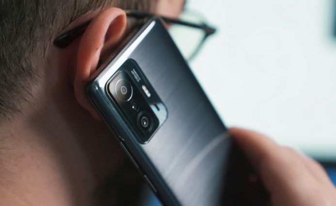 Close-up of a volunteer on a call, highlighting Open Homes Nottingham’s commitment to providing accessible support and advice to youth in need.