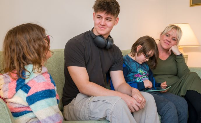 A heartwarming scene of a diverse Open Homes Nottingham family together, depicting the inclusive support network for young individuals in need.